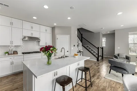 a kitchen with sink and refrigerator