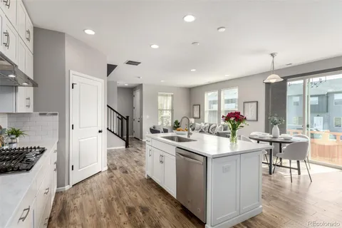 a kitchen with sink stove and cabinets