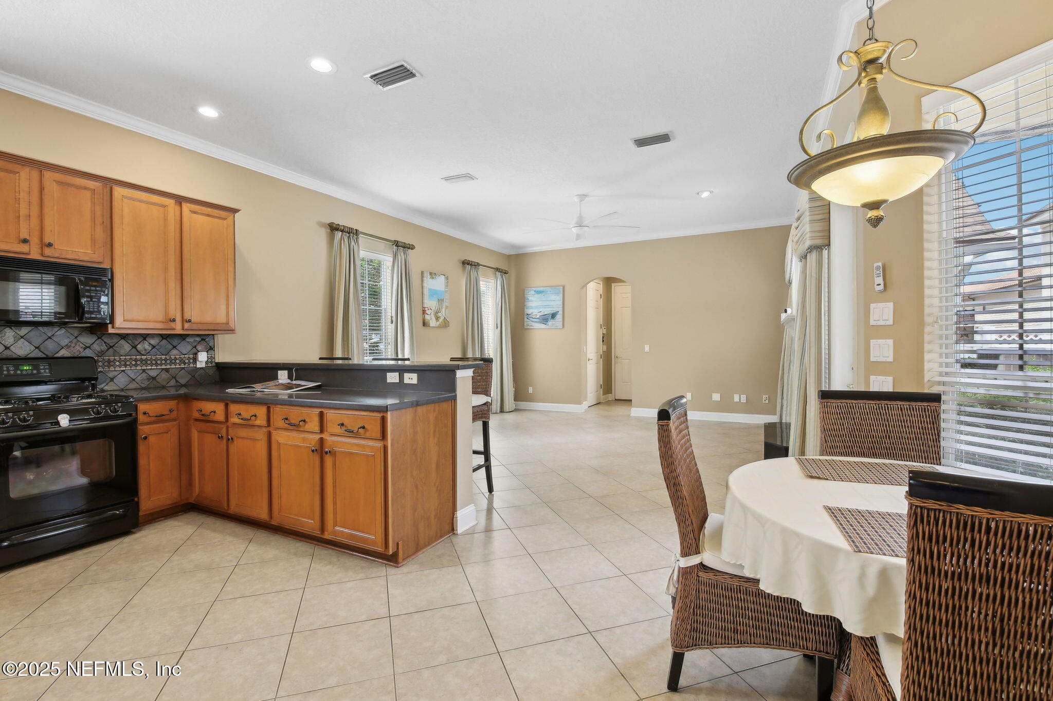 400 Central Street St. Augustine, FL 32095 - Photo 15 of 49 a large kitchen with granite countertop a stove a sink a dining table and chairs