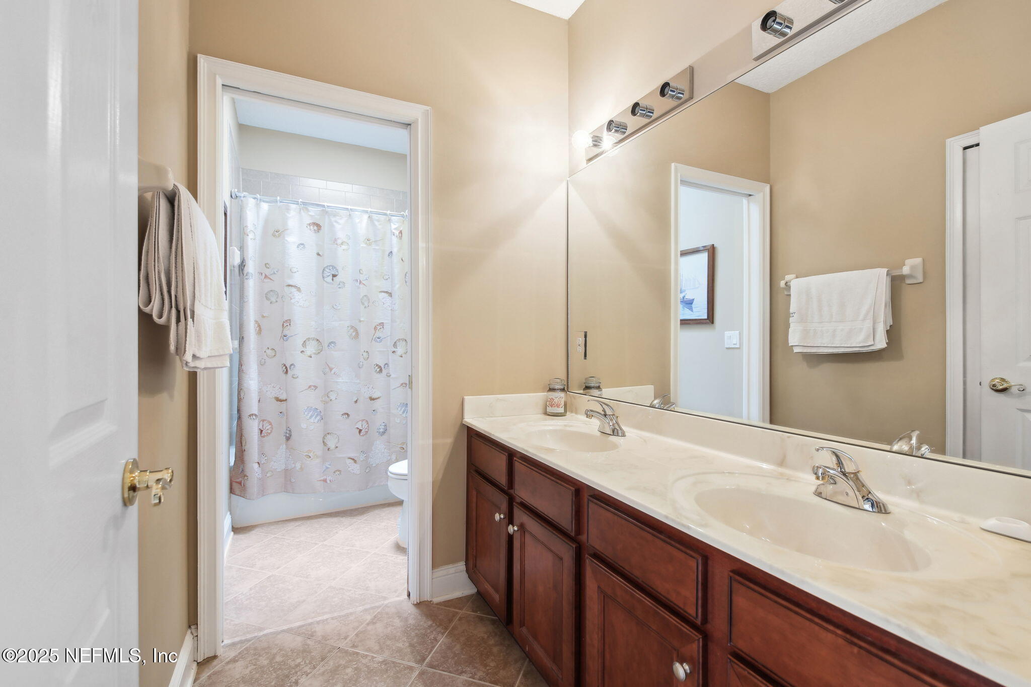 400 Central Street St. Augustine, FL 32095 - Photo 31 of 49 a bathroom with a double vanity sink mirror and shower