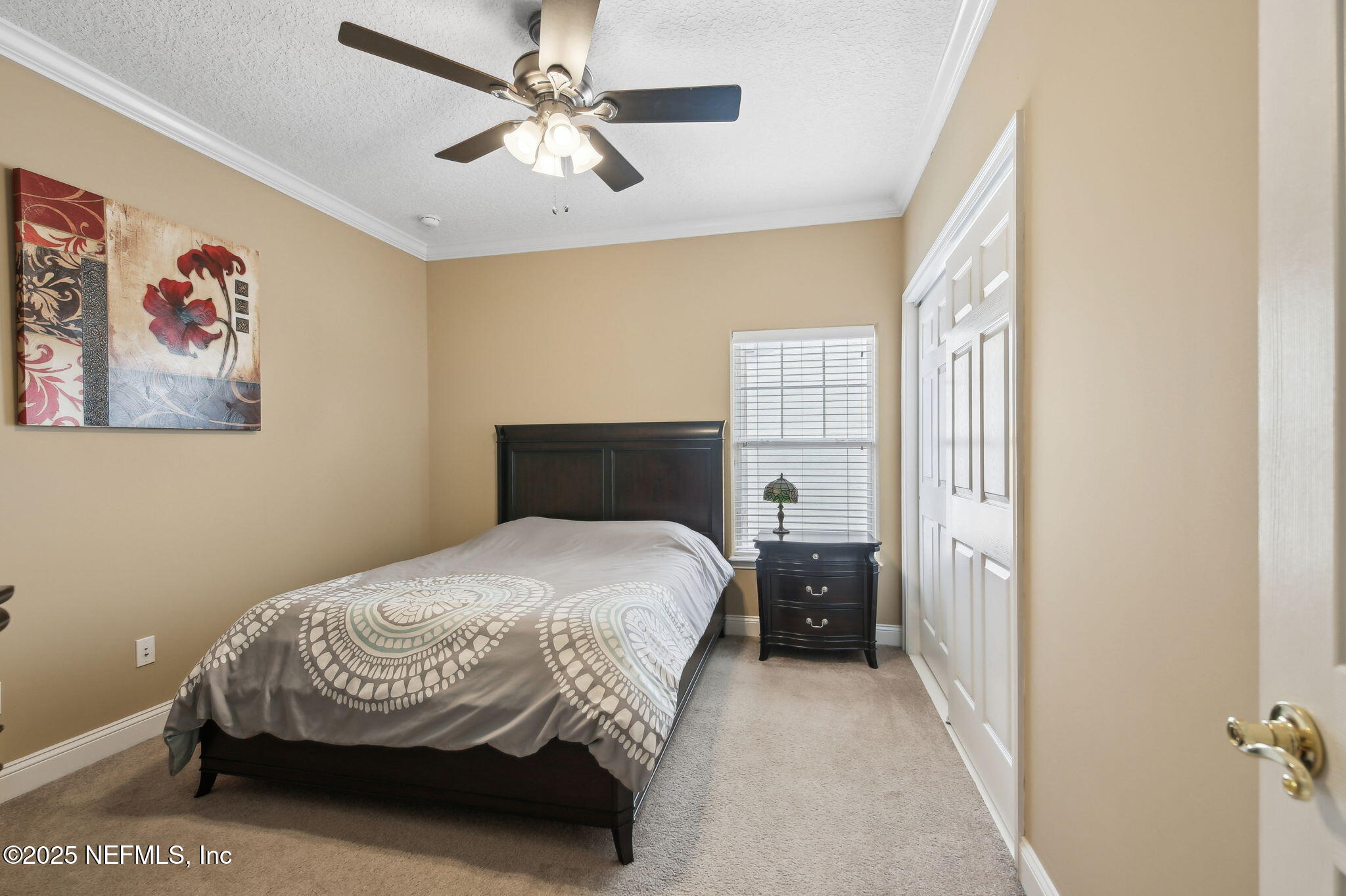 400 Central Street St. Augustine, FL 32095 - Photo 32 of 49 a bedroom with a bed and a chandelier