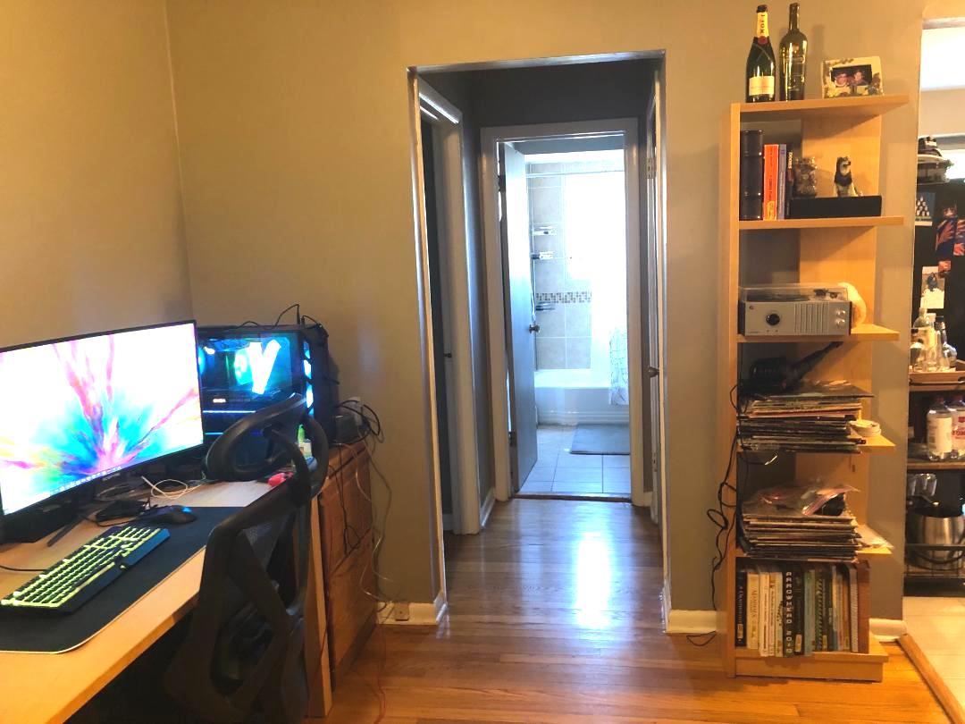 609 Oakton Street, Unit 2D Evanston, IL 60202 - Photo 4 of 7 a view of a hallway with wooden floor and furniture