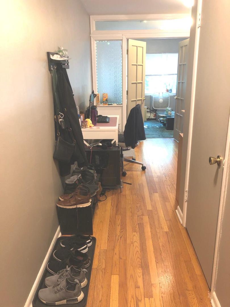 609 Oakton Street, Unit 2D Evanston, IL 60202 - Photo 7 of 7 a living room with furniture and a wooden floor