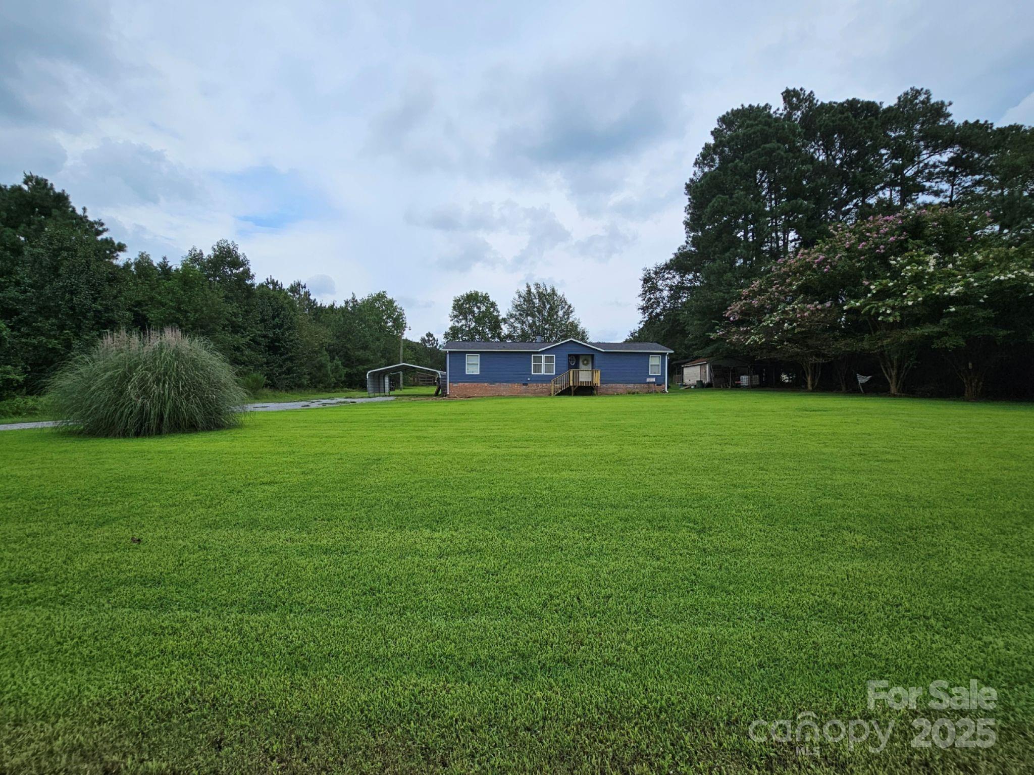 434 Howard Lingerfelt Road Vale, NC 28168 - Photo 11 of 13 a backyard with a garden and trees