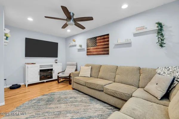 a living room with fireplace furniture and a flat screen tv