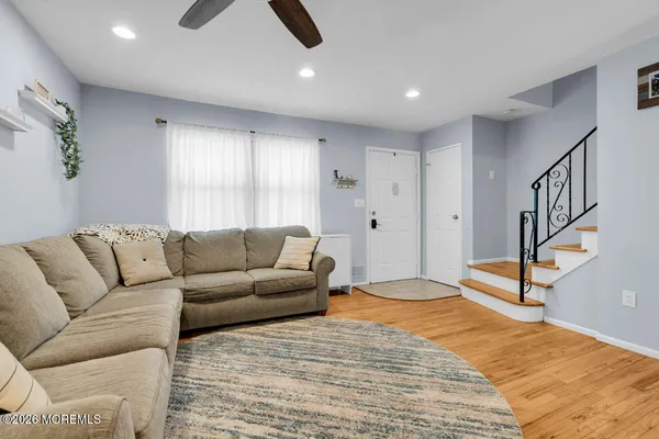 a living room with furniture and a ceiling fan