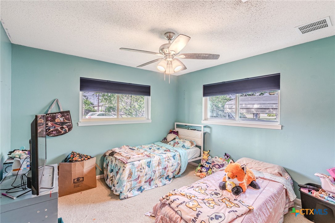 2411 Osage Road Gatesville, TX 76528 - Photo 13 of 29 Bedroom with ceiling fan and bright interior
