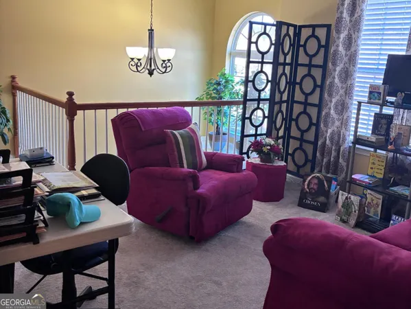 a living room with furniture a rug and a window