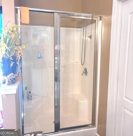 a bathroom with a glass shower door