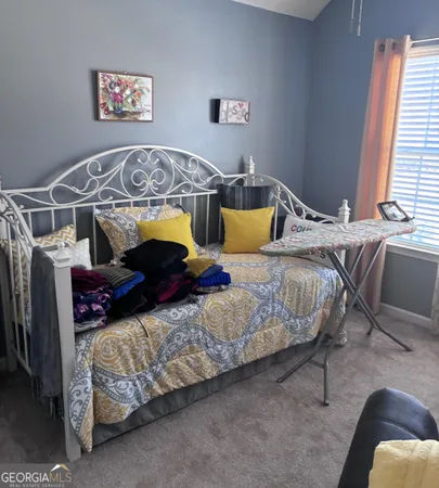 a bedroom with bed and window