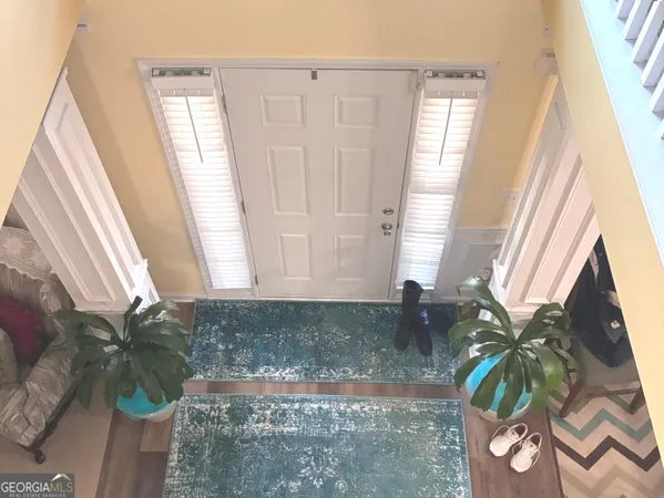 a bathroom with a sink a mirror and next to a window