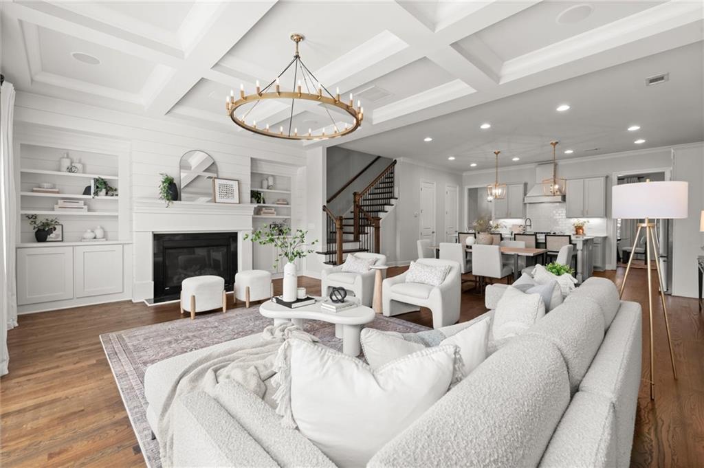 1868 Skyfall Circle Atlanta, GA 30319 - Photo 23 of 61 a living room with furniture a fireplace and a chandelier