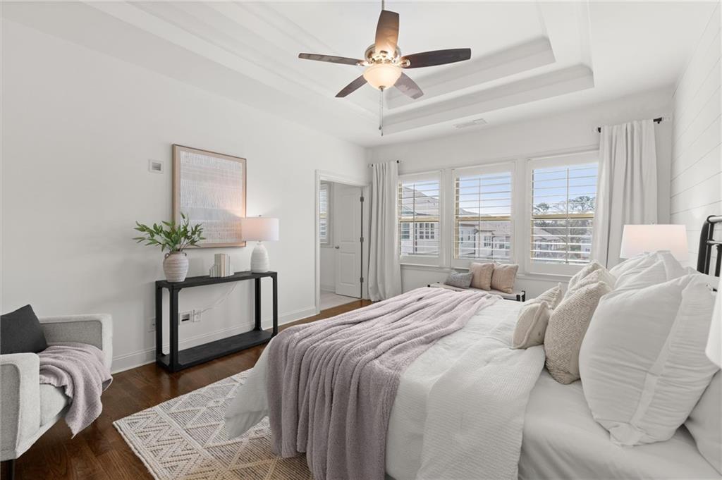 1868 Skyfall Circle Atlanta, GA 30319 - Photo 34 of 61 a bedroom with a bed a chandelier and a potted plant on a dresser