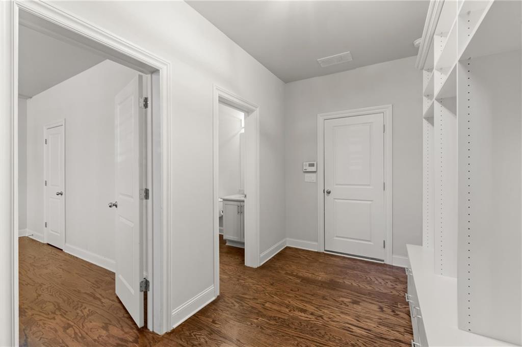 1868 Skyfall Circle Atlanta, GA 30319 - Photo 49 of 61 a view of a hallway with wooden floor