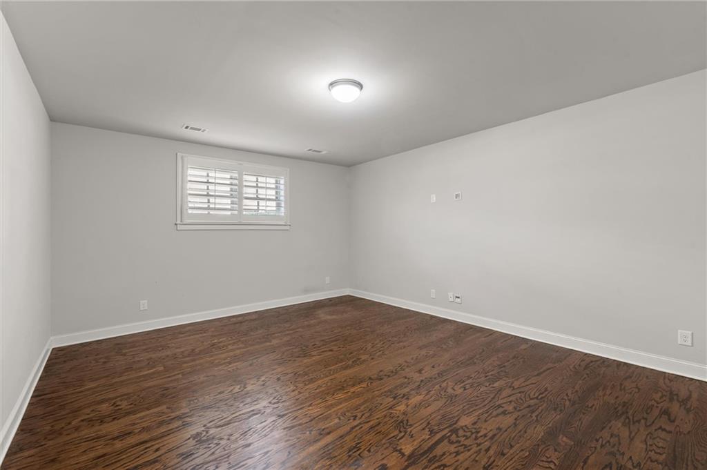 1868 Skyfall Circle Atlanta, GA 30319 - Photo 50 of 61 an empty room with wooden floor and windows