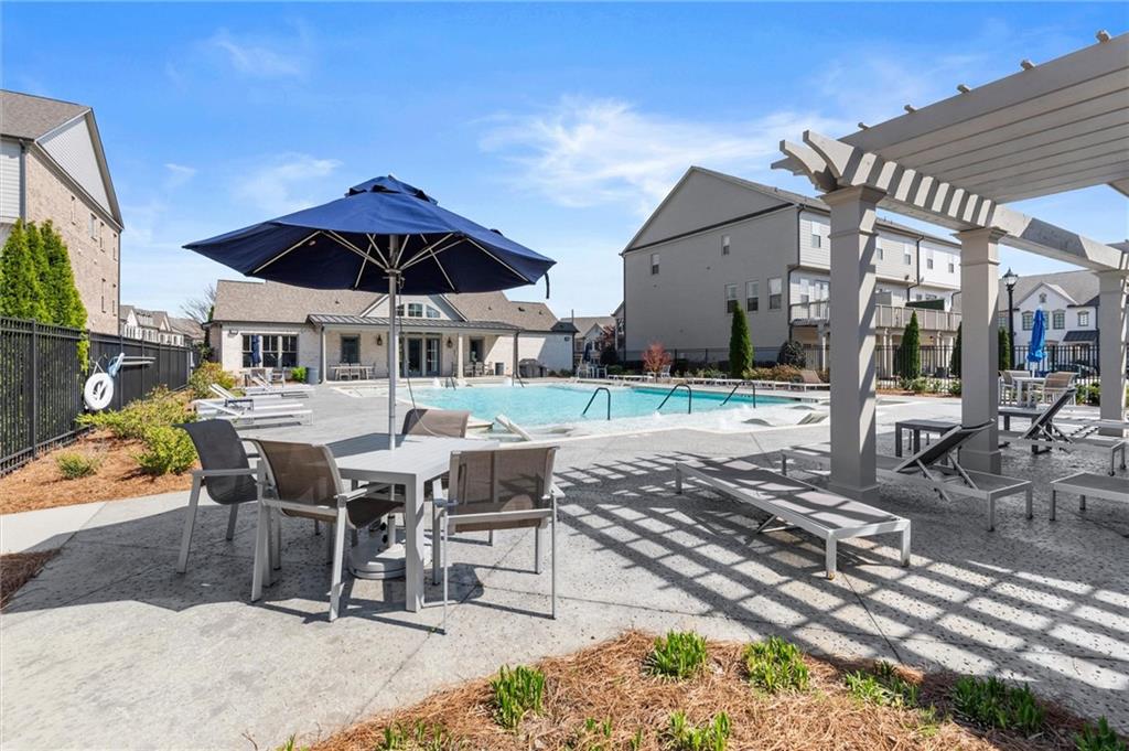 1868 Skyfall Circle Atlanta, GA 30319 - Photo 54 of 61 a view of a patio with a table and chairs under an umbrella