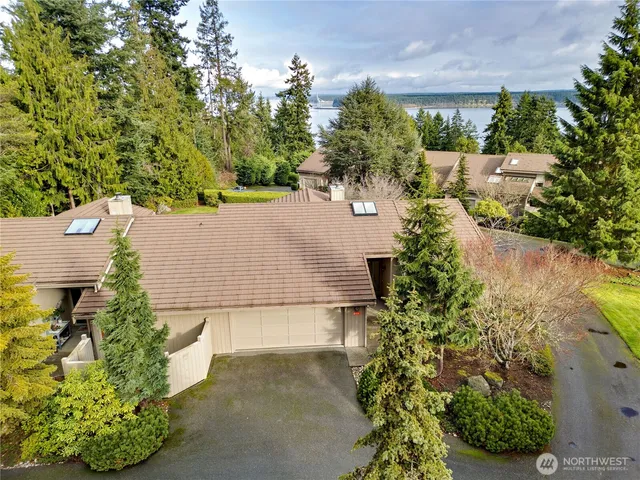 an aerial view of a house with a yard and swimming pool