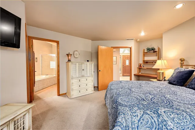 a bed room with a bed and a television