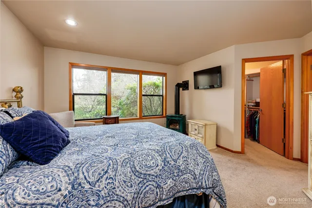 a bedroom with a large bed and a television