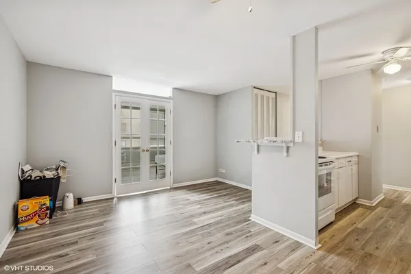 an empty room with wooden floor and cabinet