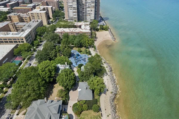 an aerial view of a residential apartment building with a yard