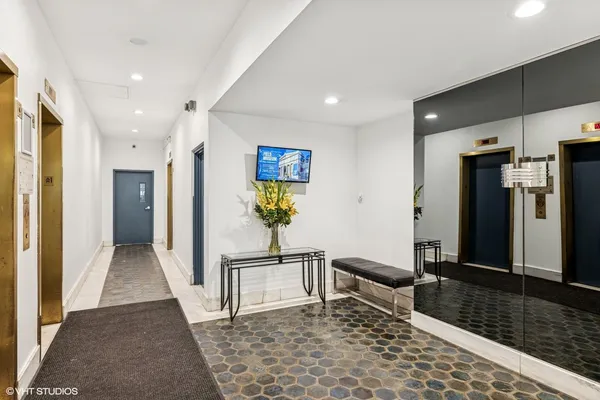 a living room with stainless steel appliances kitchen island granite countertop furniture a refrigerator and a sink