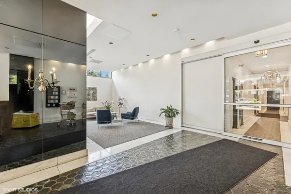 a lobby with a couch and a rug