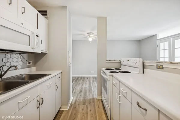 a kitchen with cabinets a sink and appliances