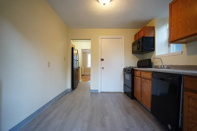 a kitchen with stainless steel appliances granite countertop a refrigerator and a stove top oven