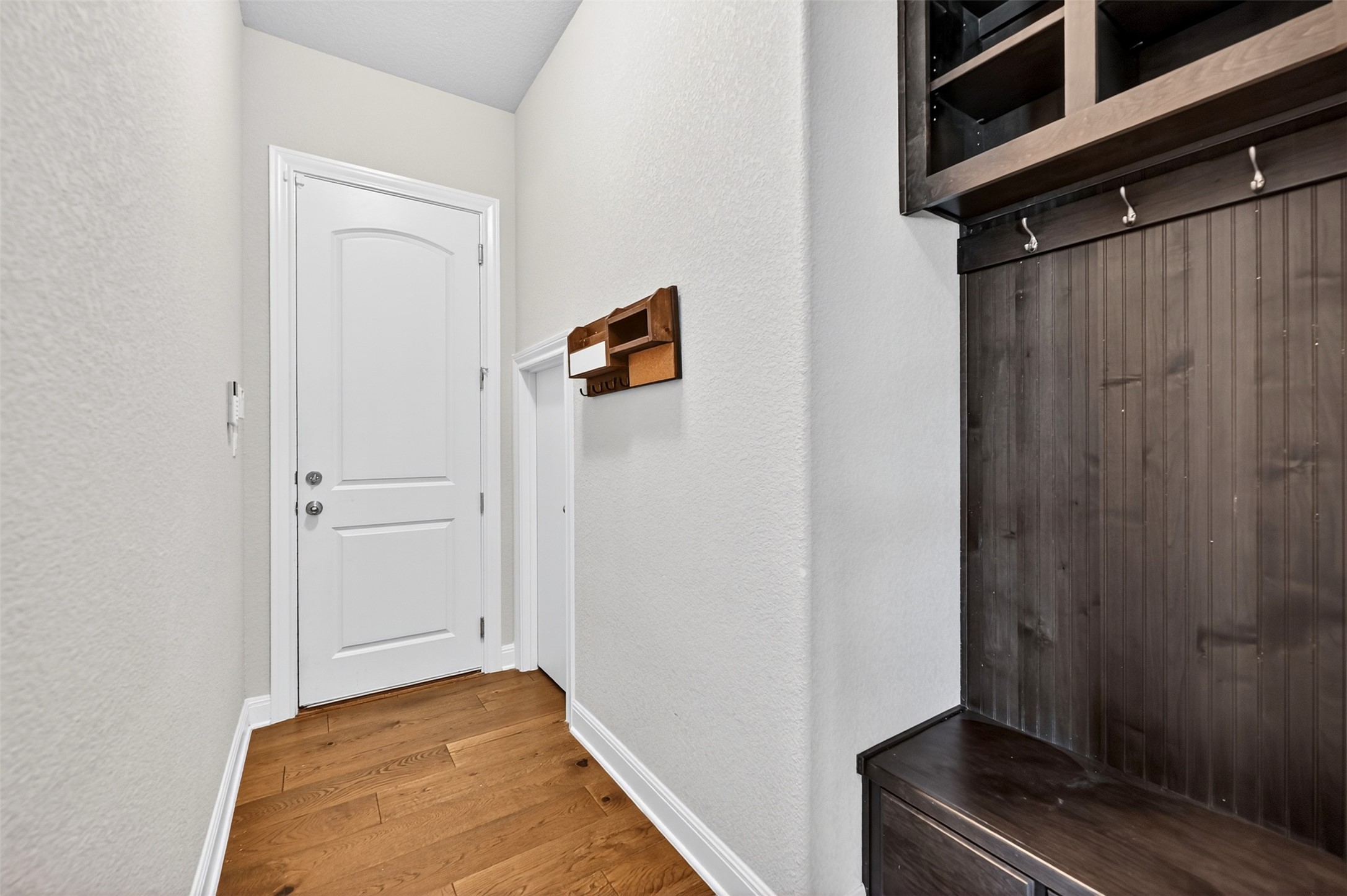 1201 Positano Pass Leander, TX 78641 - Photo 9 of 40 Entryway featuring wood-finish flooring and a built-in mudroom bench