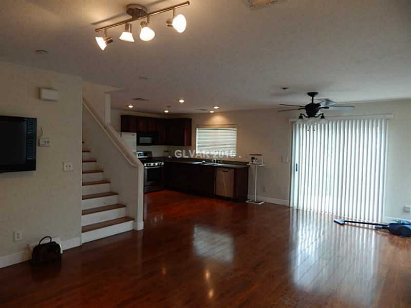 1165 Paradise River Road Henderson, NV 89002 - Photo 4 of 35 Property Photo. Large living room with a formal dining area.
