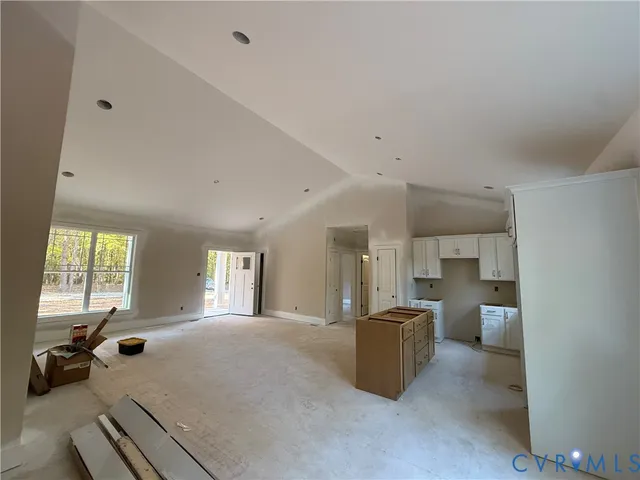 a large room with a window and furniture