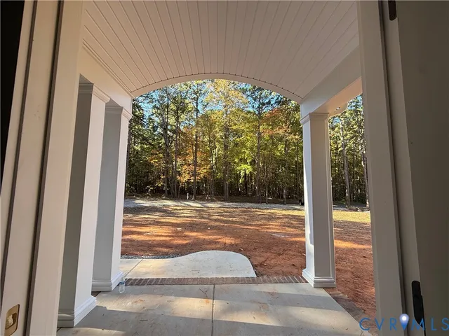 a view of a porch with a floor to ceiling window and an outdoor view