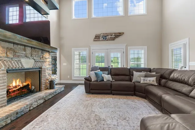 a bedroom with a bed a couch and a chandelier