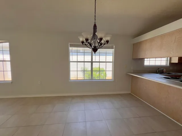 a living room with a large window a sink and a counter top space