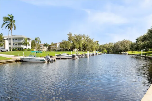 a view of a lake with houses in the back