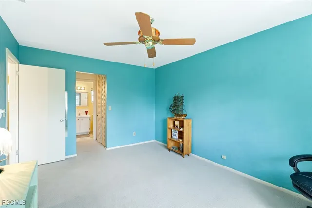 a view of a livingroom with a ceiling fan and entryway