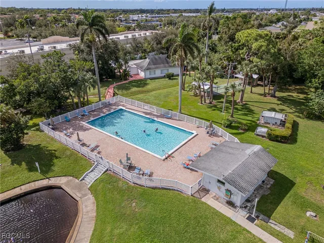 an aerial view of a house with a garden and swimming pool