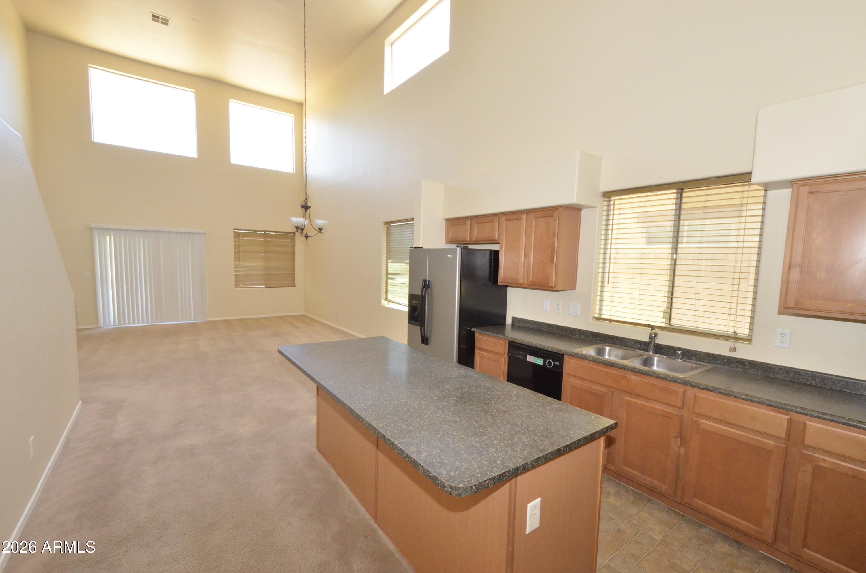 3995 East Trigger Way Gilbert, AZ 85297 - Photo 4 of 23 a kitchen with stainless steel appliances granite countertop a sink a stove and a refrigerator