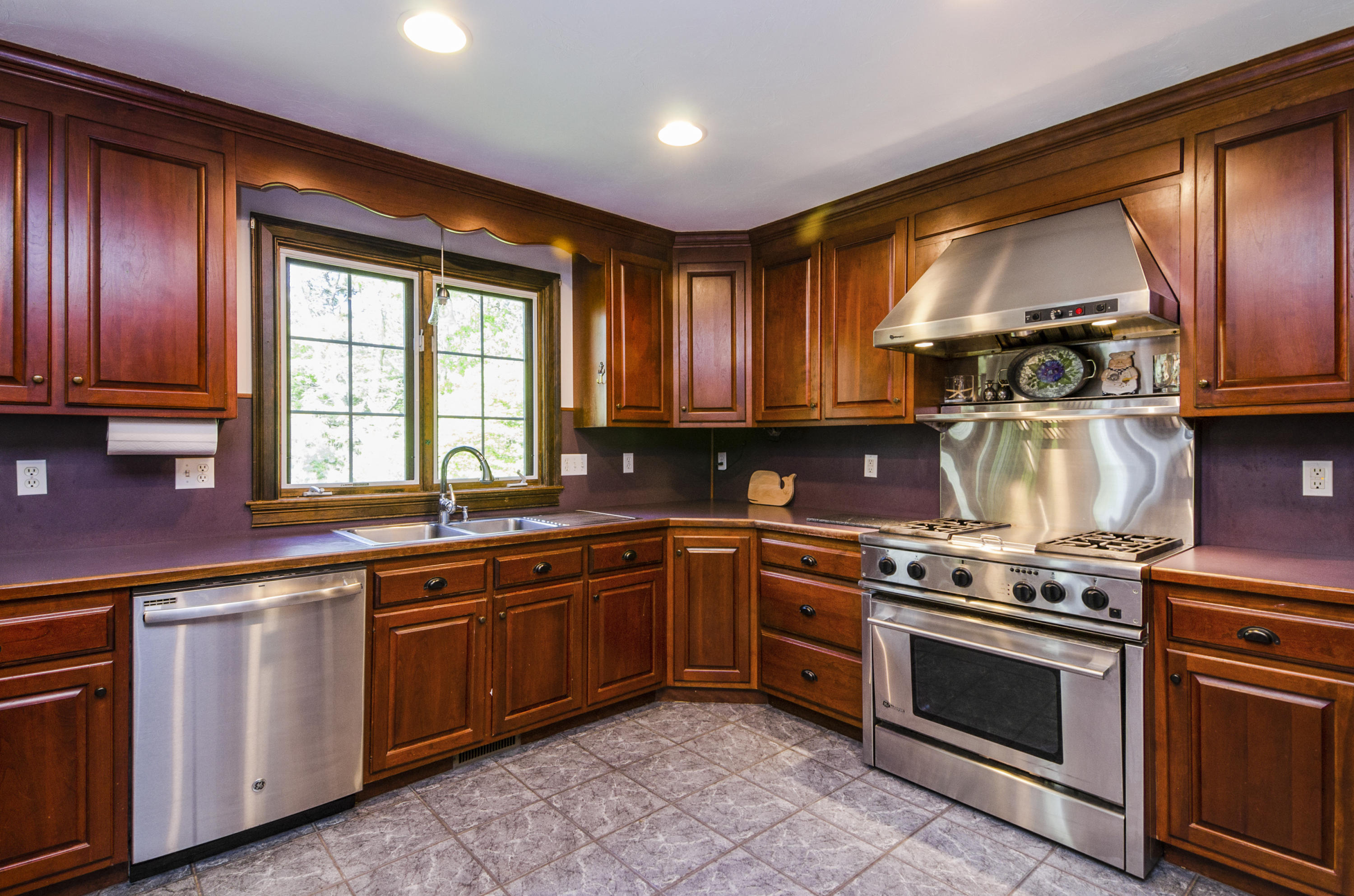 50 Waterhouse Road Bourne, MA 02532 - Photo 11 of 25 a kitchen with wooden cabinets and a stove top oven