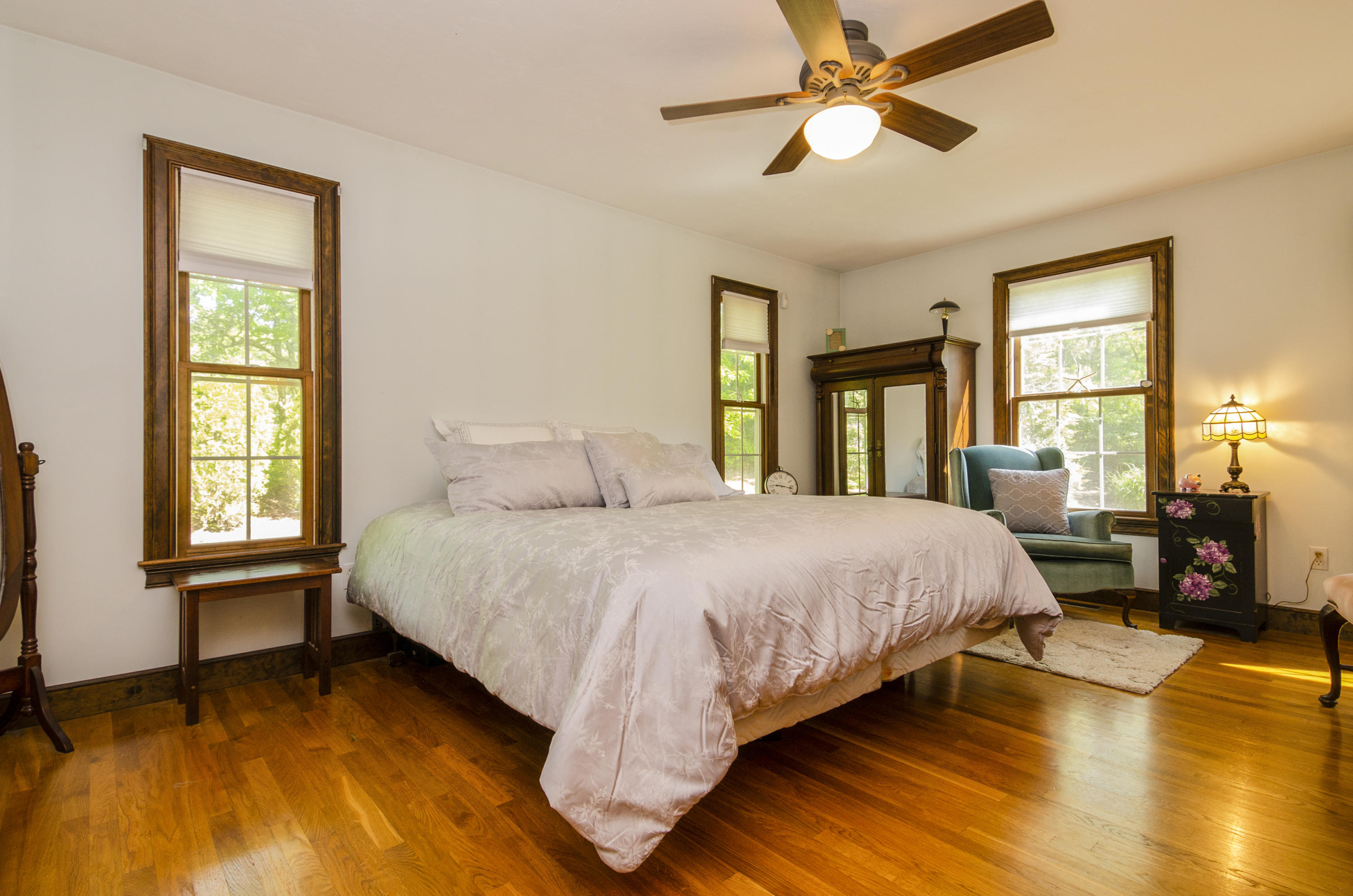 50 Waterhouse Road Bourne, MA 02532 - Photo 12 of 25 a spacious bedroom with a bed and a chandelier