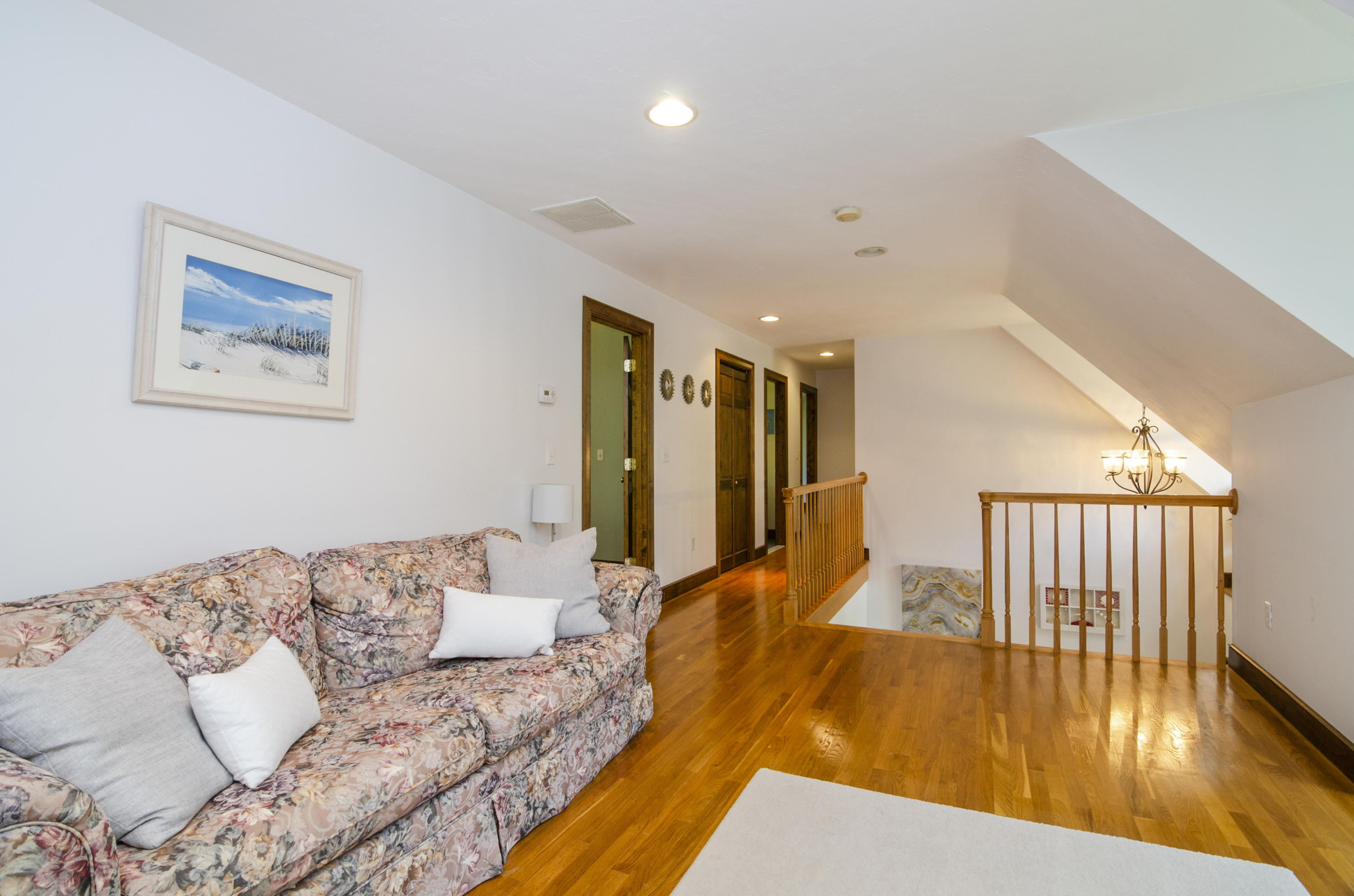 50 Waterhouse Road Bourne, MA 02532 - Photo 15 of 25 a spacious bedroom with a bed and wooden floor