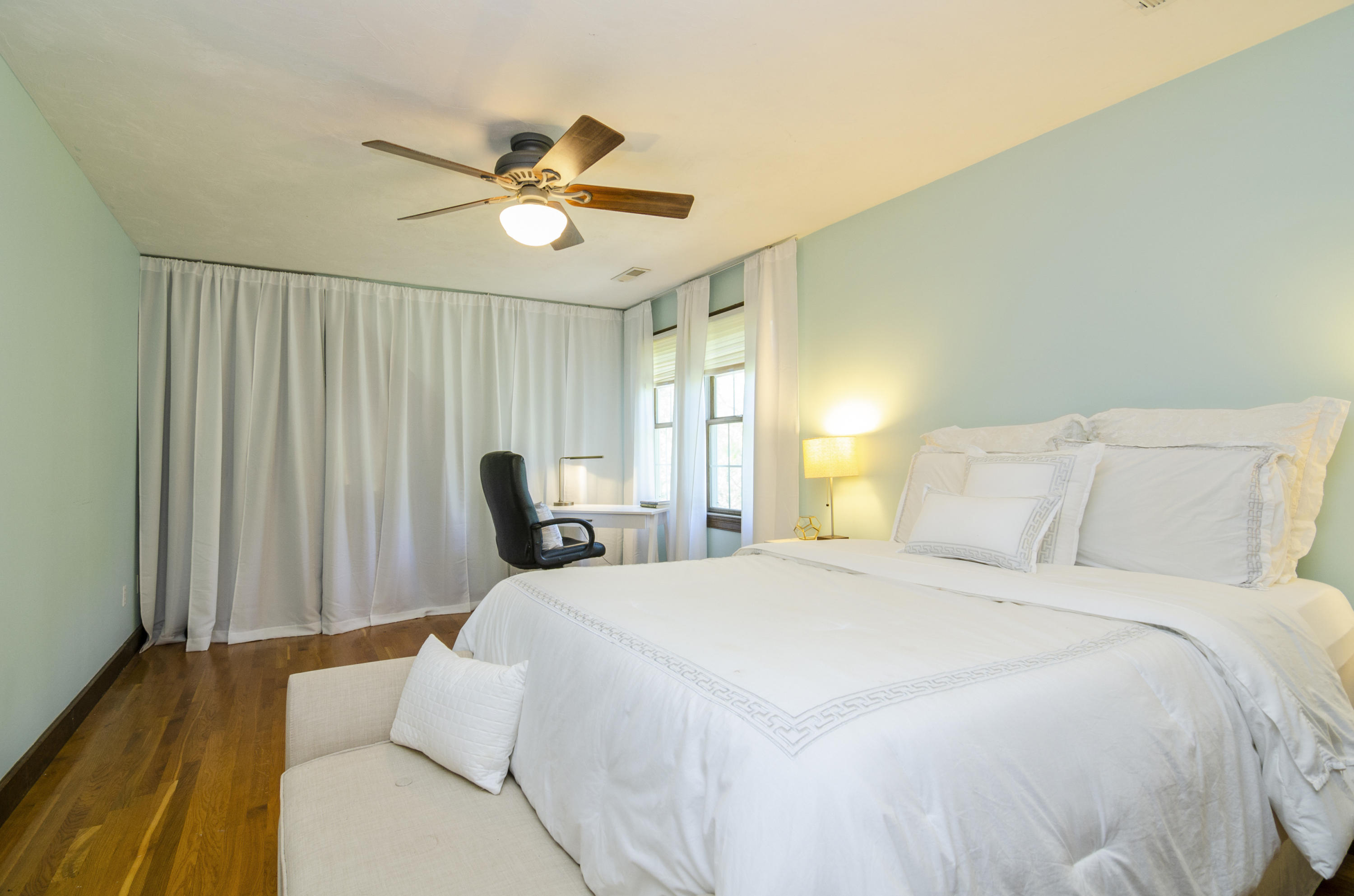 50 Waterhouse Road Bourne, MA 02532 - Photo 16 of 25 a bedroom with a bed and a chandelier