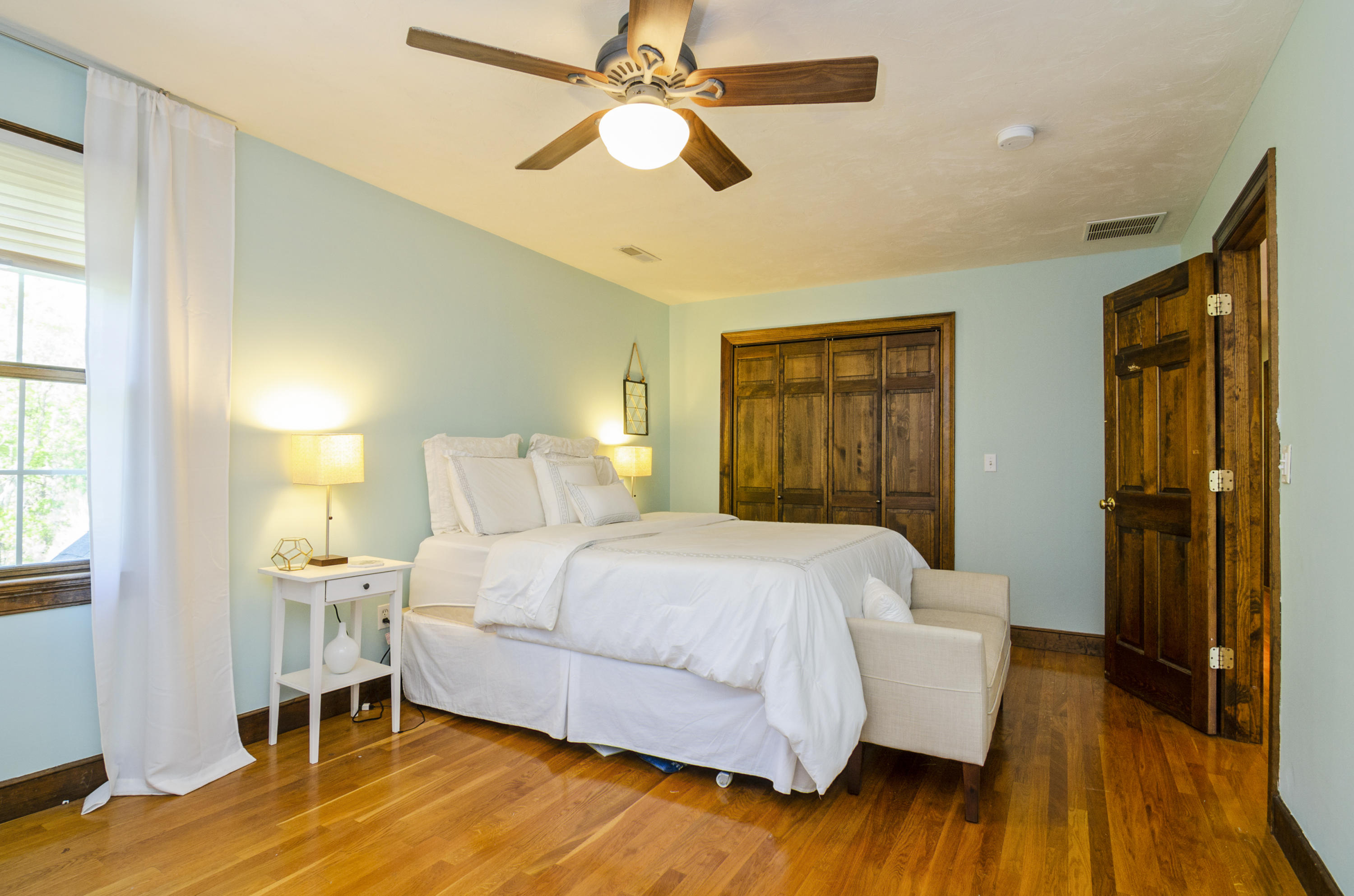 50 Waterhouse Road Bourne, MA 02532 - Photo 17 of 25 a bedroom with a bed and a chandelier