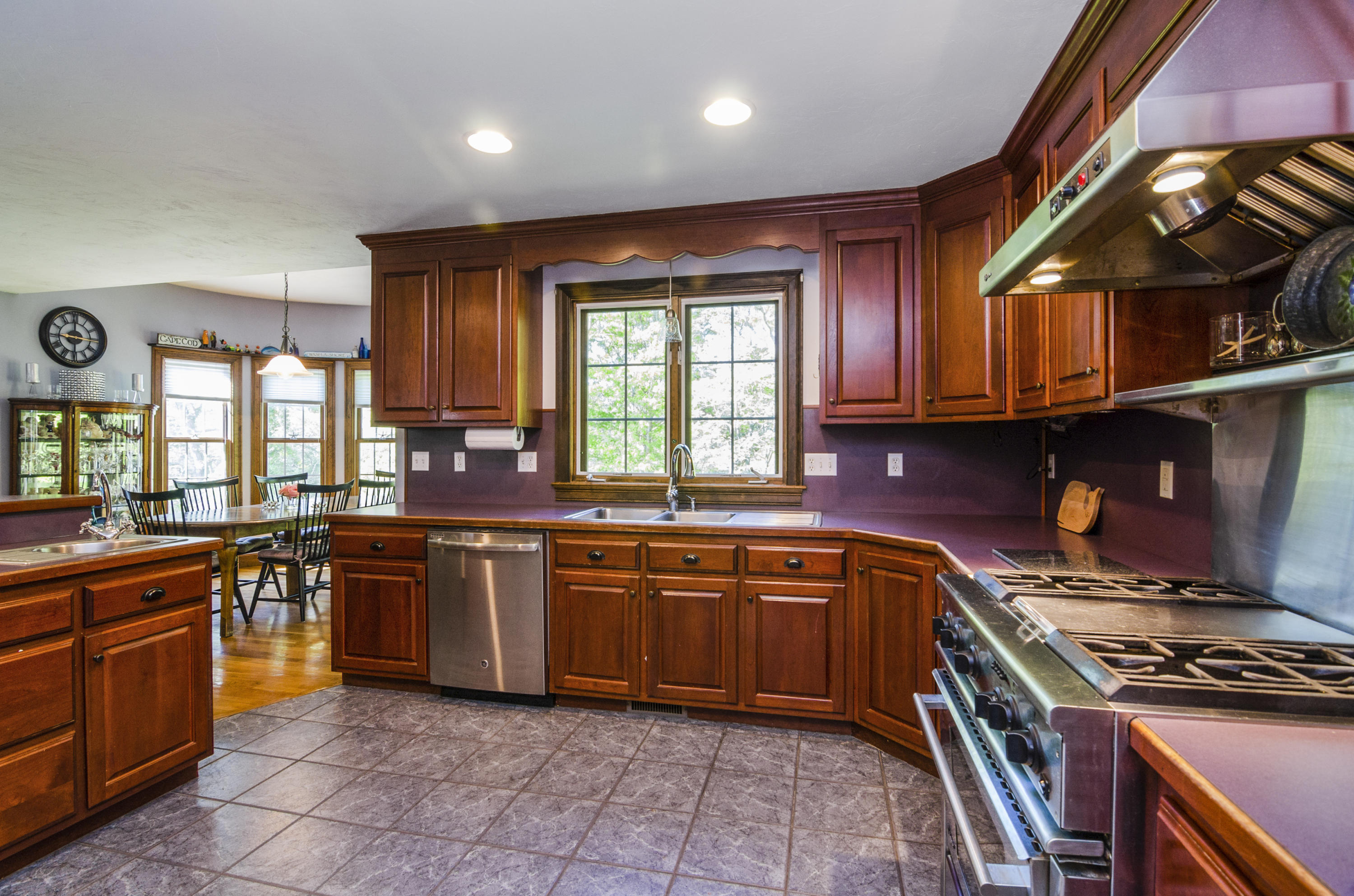 50 Waterhouse Road Bourne, MA 02532 - Photo 10 of 25 a kitchen with stainless steel appliances granite countertop wooden cabinets a sink and a stove