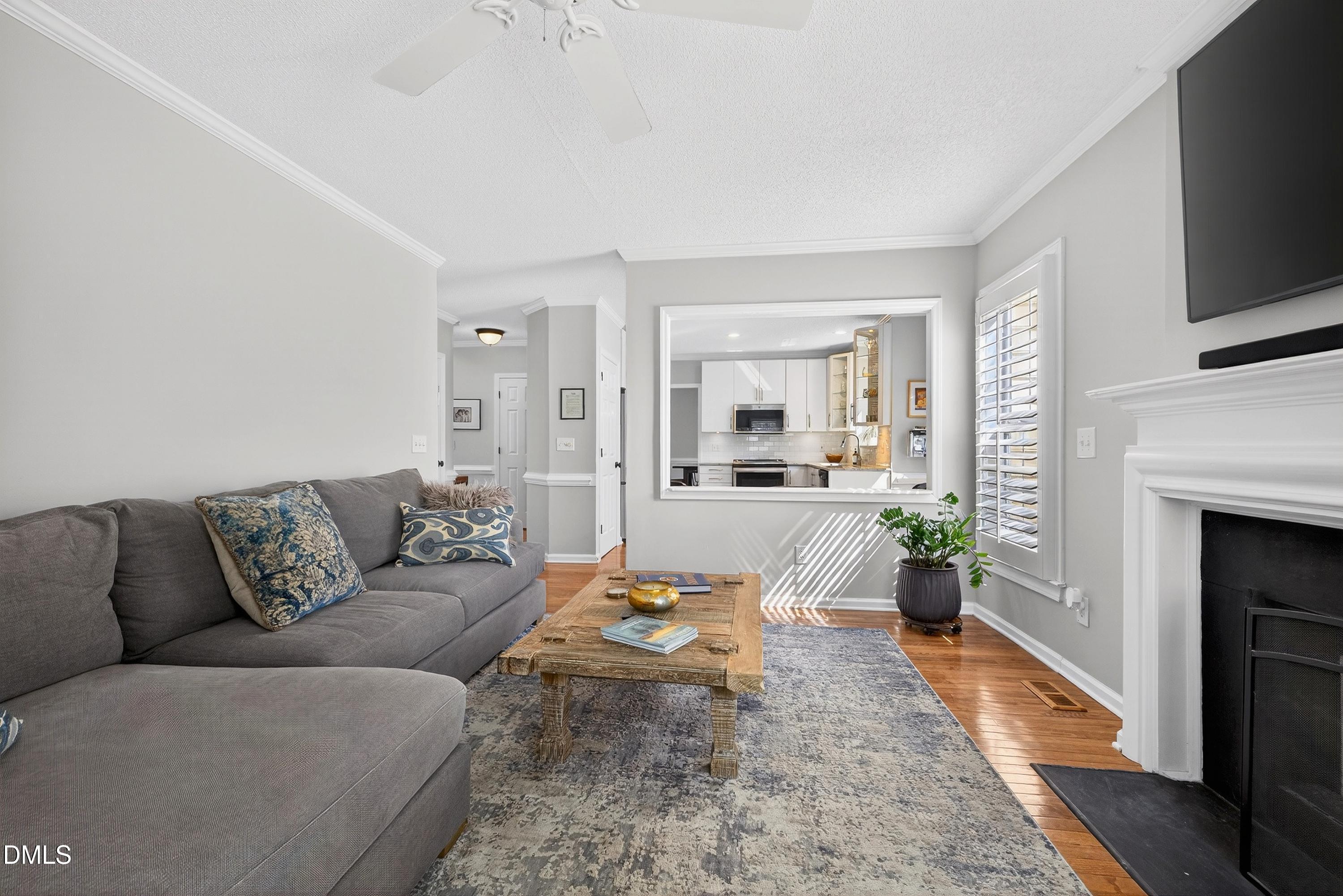 9432 Cartersville Court Raleigh, NC 27617 - Photo 26 of 66 a living room with furniture and a fireplace