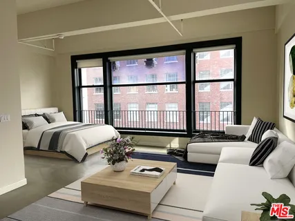 a bedroom with bed and a large window