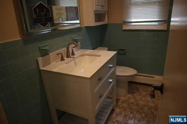 a bathroom with a sink toilet and mirror