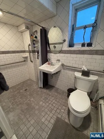 a bathroom with a toilet a sink and mirror