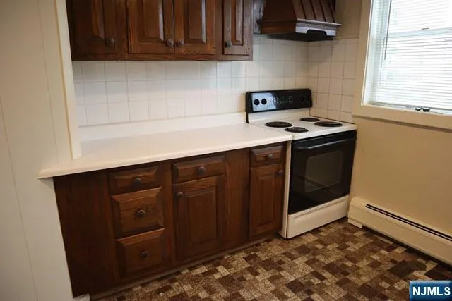 a kitchen with stainless steel appliances granite countertop a stove and a microwave